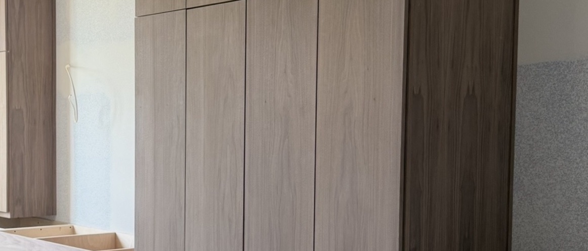 Custom cabinetry — tall white oak cabinet run
